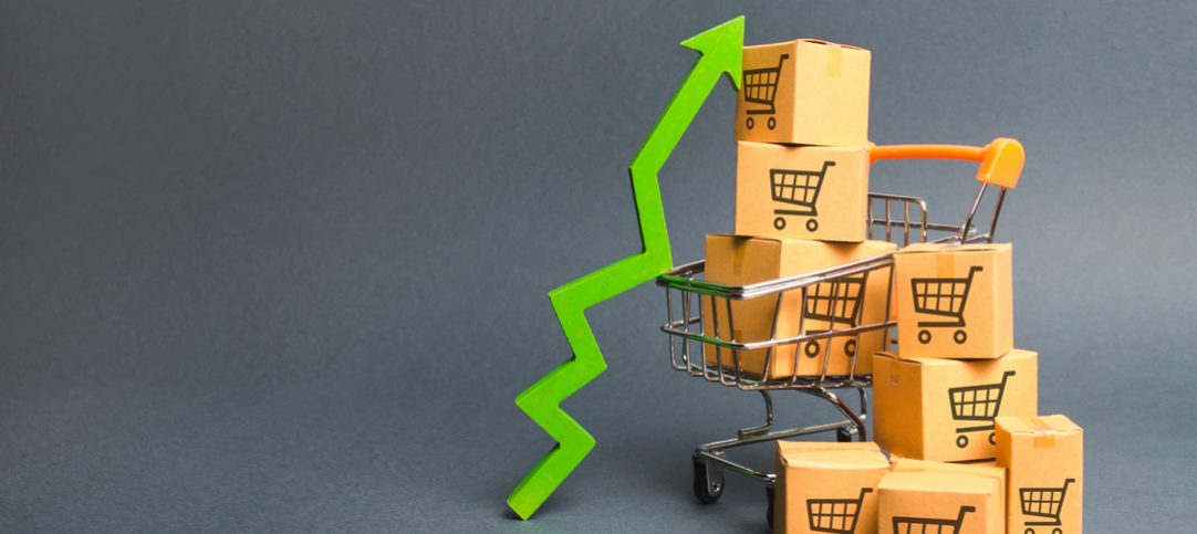 Carrinho de compras cheio ao lado de um gráfico crescente para representar os lucros da black friday 2022.