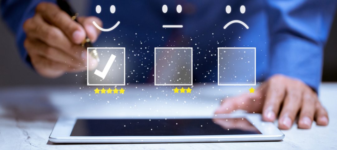 Imagem mostra um usuário fazendo uma boa avaliação de uma empresa em um tablet, graças as boas técnicas de tendências de comportamento do cliente.